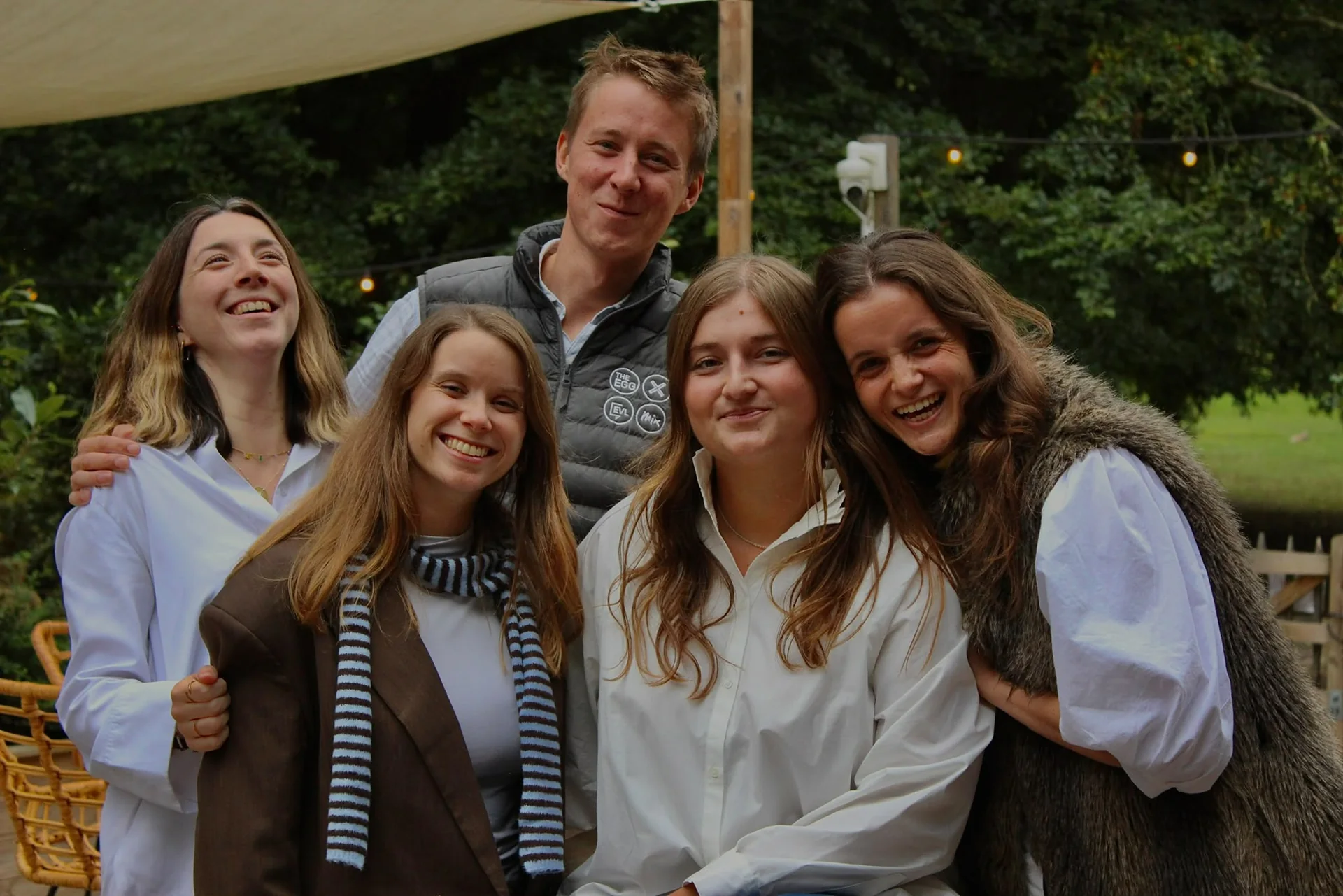 Five people gathered together outdoors