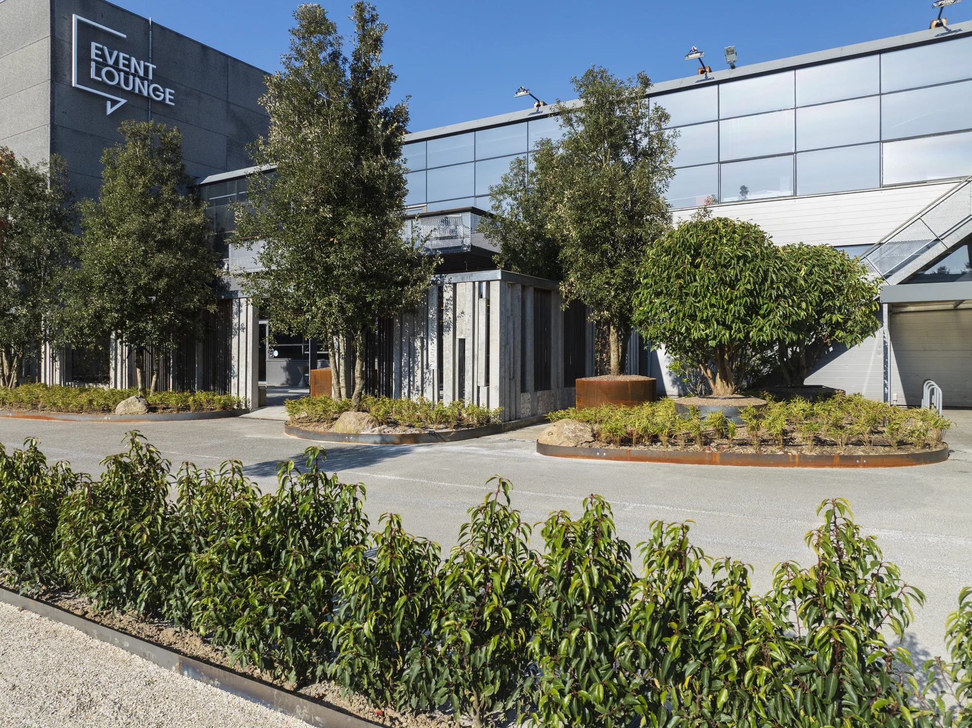 The entrance to Event Lounge with landscaped planting and trees
